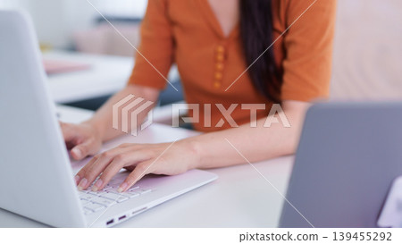 Asian women typing laptop computer hands keyboard working from home office hybrid work remote worker professional businesswoman online freelancer digital Asian women typing laptop computer hands keyboard working from home office hybrid work remote worker professional businesswoman online freelancer digital 139455292