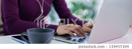 asian women working remotely from home office using laptop computer typing on keyboard with coffee cup on desk hybrid work lifestyle concept morning 139455304