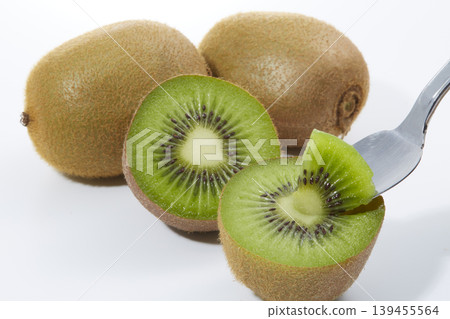 An image of a fresh green kiwi placed against a white background. An image of a fresh green kiwi placed against a white background. 139455564
