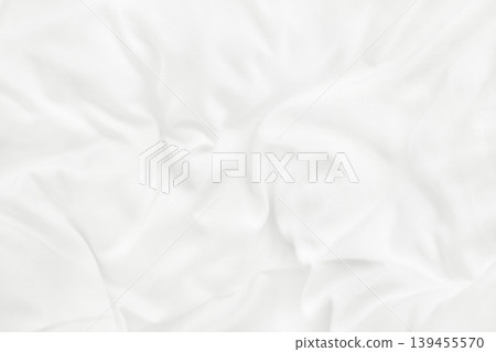 Close up top view of white bedding sheet and wrinkle messy blanket in bedroom after wake up in the morning. 139455570