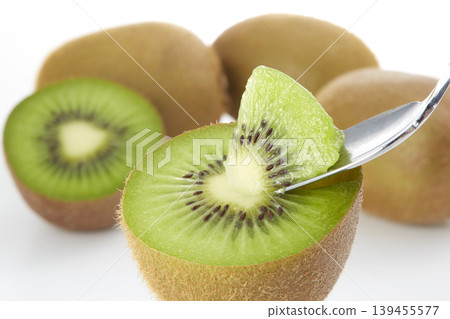 An image of a fresh green kiwi placed against a white background. An image of a fresh green kiwi placed against a white background. 139455577