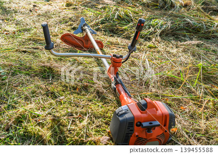 String trimmer on grass, versatile lawn care equipment for mowing and precise edging yard work String trimmer on grass, versatile lawn care equipment for mowing and precise edging yard work 139455588