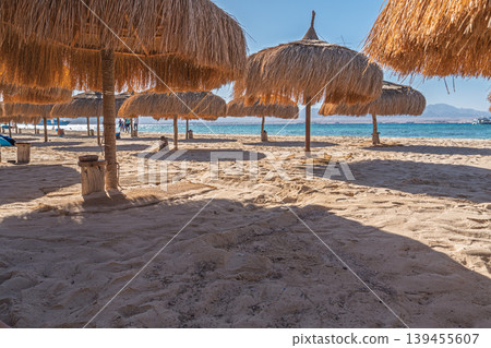 Beach Umbrellas and Sand at Sharm el-Sheikh, Egypt on a Sunny Day for Summer Vacation Beach Umbrellas and Sand at Sharm el-Sheikh, Egypt on a Sunny Day for Summer Vacation 139455607