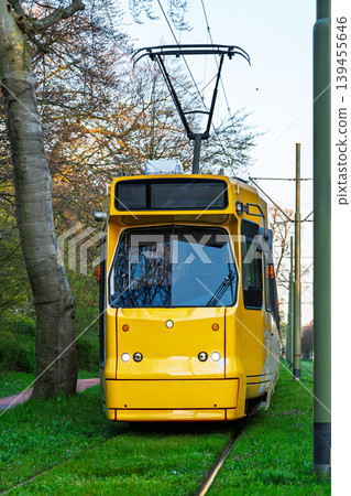Bright yellow tram on grass tracks in Dusseldorf, Germany, public transportation concept Bright yellow tram on grass tracks in Dusseldorf, Germany, public transportation concept 139455646