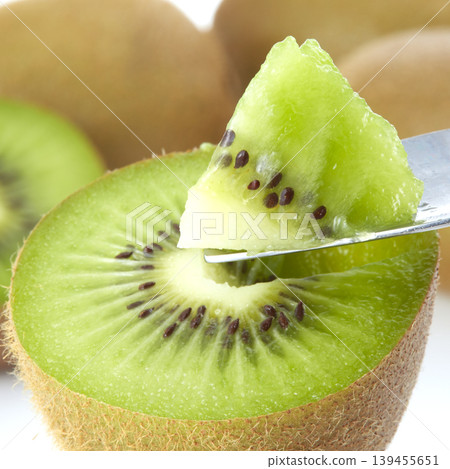 An image of a fresh green kiwi placed against a white background. An image of a fresh green kiwi placed against a white background. 139455651