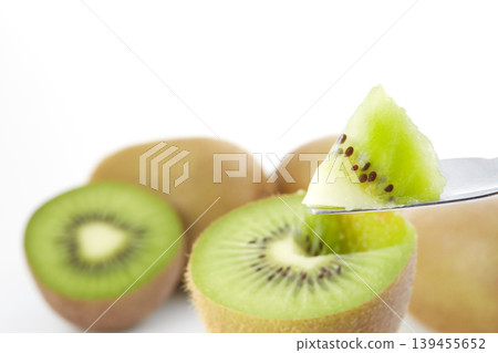 An image of a fresh green kiwi placed against a white background. An image of a fresh green kiwi placed against a white background. 139455652