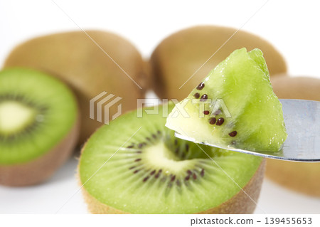 An image of a fresh green kiwi placed against a white background. An image of a fresh green kiwi placed against a white background. 139455653