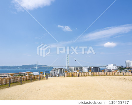 A breathtaking view of the Akashi Kaikyo Bridge from the Goshikizuka Tumulus, where ancient and modern times intersect. A breathtaking view of the Akashi Kaikyo Bridge from the Goshikizuka Tumulus, where ancient and modern times intersect. 139455727