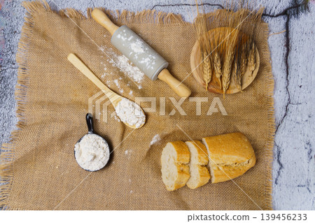Baking ingredients with rolling pin, flour, and sliced bread Baking ingredients with rolling pin, flour, and sliced bread 139456233