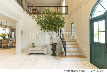 Luxury Home Entrance and Stairway Foyer with house plane and green door. 139456398