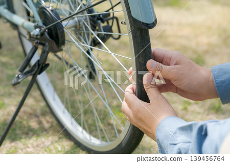 The hands of a person who maintains bicycles 139456764