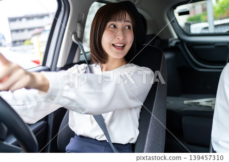 一位微笑的女士開車,她的朋友坐在副駕駛座上。 (駕駛生活方式) 一位微笑的女士開車,她的朋友坐在副駕駛座上。 (駕駛生活方式) 139457310