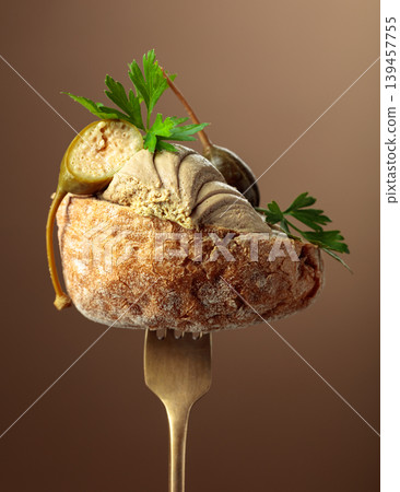Bread with liver pate, capers, and fresh parsley on a fork. Bread with liver pate, capers, and fresh parsley on a fork. 139457755