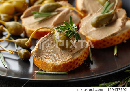 Sandwiches with pate on a black plate. Sandwiches with pate on a black plate. 139457792