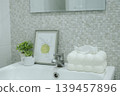 White ceramic sink with modern tissue box and decorative items in bathroom. 139457896