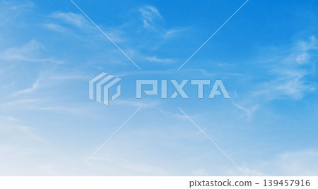 Clear sky with wispy clouds drifting softly 139457916