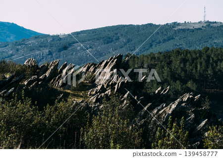 Jagged rock formation on mountainside with communication tower Jagged rock formation on mountainside with communication tower 139458777