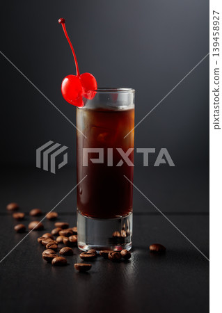 Coffee liquor with ice in tall glass on a black background. Coffee liquor with ice in tall glass on a black background. 139458927