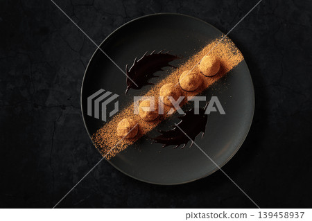 Chocolate truffles on a black plate. Chocolate truffles on a black plate. 139458937