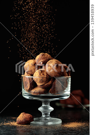 Chocolate truffles sprinkled with cocoa powder. Chocolate truffles sprinkled with cocoa powder. 139458939