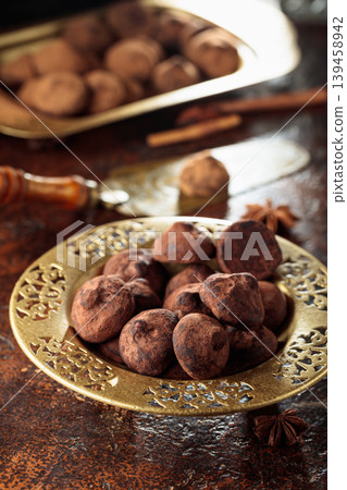 Chocolate truffles in old brass dish. Chocolate truffles in old brass dish. 139458942