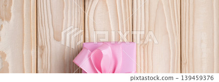 Pink gift box ribbon wooden background Pink gift box ribbon wooden background 139459376