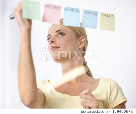 Business woman, writing and schedule planning on sticky notes or glass board for project or time management. Creative planner or worker with priority list, calendar or brainstorming of workflow ideas Business woman, writing and schedule planning on sticky notes or glass board for project or time management. Creative planner or worker with priority list, calendar or brainstorming of workflow ideas 139460678