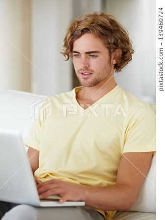 Laptop, remote work and man on a sofa for research, planning or web communication in his home. Tech, freelance and male entrepreneur online in a living room with social media, search or streaming Laptop, remote work and man on a sofa for research, planning or web communication in his home. Tech, freelance and male entrepreneur online in a living room with social media, search or streaming 139460724