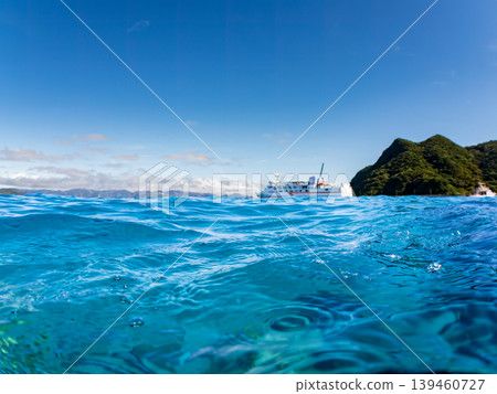 A half-submerged photo of Aka Beach on Aka Island. A ferry is passing in the distance. Aka Beach (Majyahama), Kerama Islands, Shimajiri District, Okinawa Prefecture A half-submerged photo of Aka Beach on Aka Island. A ferry is passing in the distance. Aka Beach (Majyahama), Kerama Islands, Shimajiri District, Okinawa Prefecture 139460727