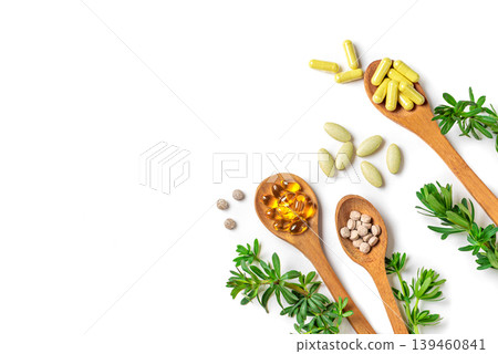 Natural herbal vitamins, plant based supplements and green leaves Natural herbal vitamins, plant based supplements and green leaves 139460841