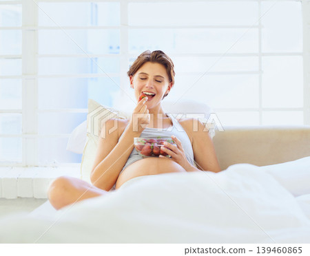 Breakfast in bed, eating and pregnant woman with strawberry bowl in a house, happy or hungry. Fruit, smile and female person in bedroom with pregnancy nutrition for health, balance or wellness Breakfast in bed, eating and pregnant woman with strawberry bowl in a house, happy or hungry. Fruit, smile and female person in bedroom with pregnancy nutrition for health, balance or wellness 139460865