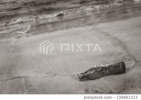 Plastic bottle stranded washed up garbage pollution on beach Brazil. 139461323