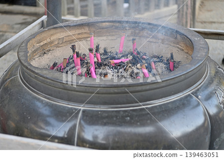 A temple incense burner and incense sticks; the rising smoke purifies the soul—a traditional scene of prayer. A temple incense burner and incense sticks; the rising smoke purifies the soul—a traditional scene of prayer. 139463051