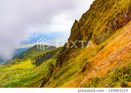 A sea of clouds and autumn foliage viewed from Mount Bandai: The contrast between the rising clouds and the autumn-colored mountain slopes. Fukushima Prefecture. A sea of clouds and autumn foliage viewed from Mount Bandai: The contrast between the rising clouds and the autumn-colored mountain slopes. Fukushima Prefecture. 139463224
