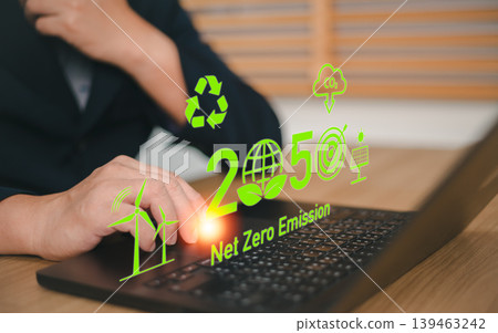 Business person using laptop with virtual green 2050 Net Zero Emission and renewable energy icons. Concept of corporate social responsibility, carbon neutrality and sustainable development goals Business person using laptop with virtual green 2050 Net Zero Emission and renewable energy icons. Concept of corporate social responsibility, carbon neutrality and sustainable development goals 139463242