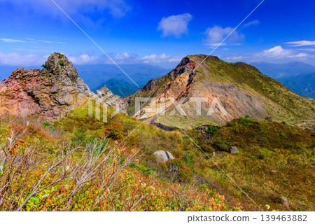 巍峨的磐梯山和串峰山峰在藍天的映襯下顯得格外雄偉,秋葉繽紛,空氣清新怡人。福島縣。 巍峨的磐梯山和串峰山峰在藍天的映襯下顯得格外雄偉,秋葉繽紛,空氣清新怡人。福島縣。 139463882