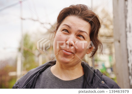 Funny middle aged woman making silly face outdoors Funny middle aged woman making silly face outdoors 139463979