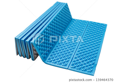 Blue and silver folding foam camping mat with thermal insulation isolated. 139464370