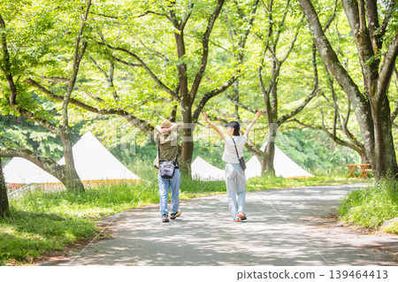 A couple walking in the fresh green A couple walking in the fresh green 139464413