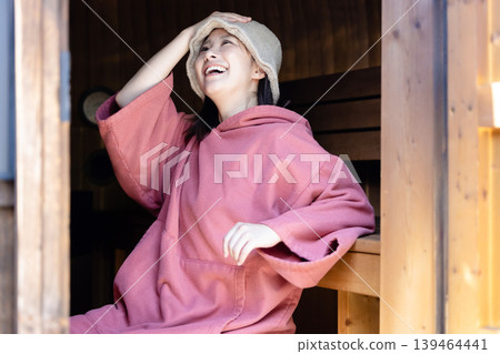 Woman enjoying the sauna Woman enjoying the sauna 139464441