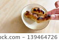 A hand eating kankoro mochi (left margin) 139464726