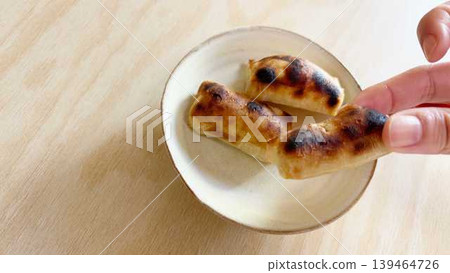 A hand eating kankoro mochi (left margin) 139464726