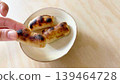 A hand eating kankoro mochi (right margin) 139464728