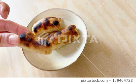 A hand eating kankoro mochi (right margin) A hand eating kankoro mochi (right margin) 139464728