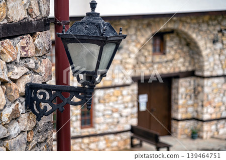 Lamp post stands near stone wall in Skopje, North Macedonia on a clear day 139464751