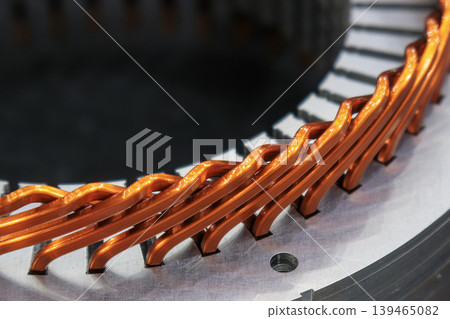 Close-up of high-quality copper wire winding assembly in a high-efficiency electric motor. Close-up of high-quality copper wire winding assembly in a high-efficiency electric motor. 139465082