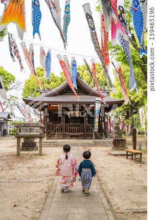 Children walking along the shrine path with carp streamers Children walking along the shrine path with carp streamers 139465196