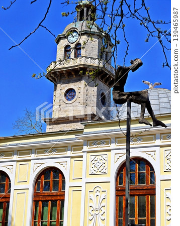 the old Clock Tower and a creative bronze monument with a seagull. the old Clock Tower and a creative bronze monument with a seagull. 139465987