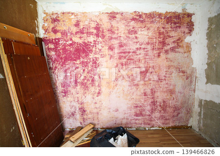 Room with plaster on scratched walls during repair with visible rough texture and unfinished surfaces. Interior renovation process, construction work, and home improvement theme. Room with plaster on scratched walls during repair with visible rough texture and unfinished surfaces. Interior renovation process, construction work, and home improvement theme. 139466826