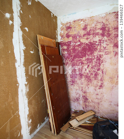 Room with plaster on scratched walls during repair with visible rough texture and unfinished surfaces. Interior renovation process, construction work, and home improvement theme. Room with plaster on scratched walls during repair with visible rough texture and unfinished surfaces. Interior renovation process, construction work, and home improvement theme. 139466827